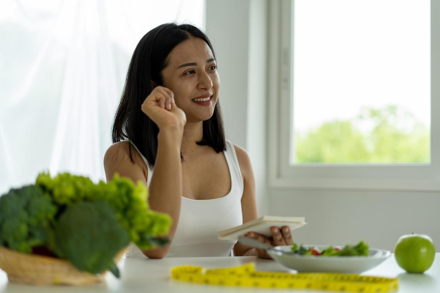 Young Asian women are losing weight, choosing to eat fruits and vegetables for good health. Women are planning a healthy diet to eat at each meal. Diet concept photo