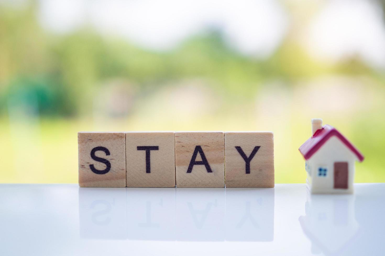 The letters in the wooden blocks say stay at home. Controlling yourself at home is a preventive measure against the outbreak of the virus. Quid-19. Social distance and stay home and stay safe. photo