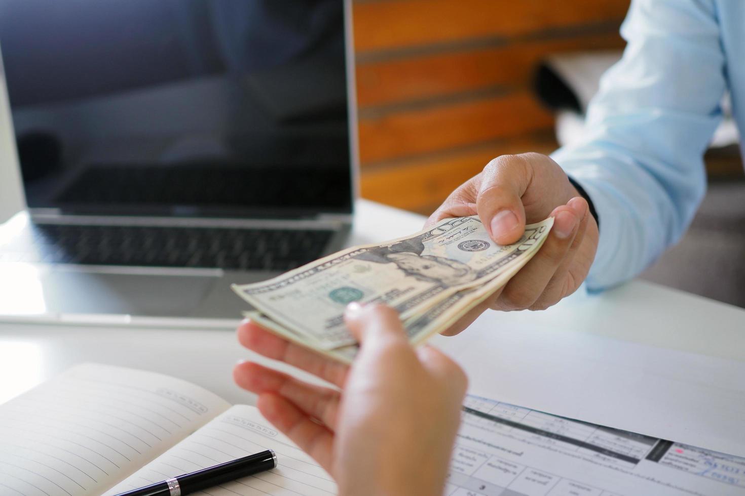 People holding money to pay interest to bank employees. Pay cash photo