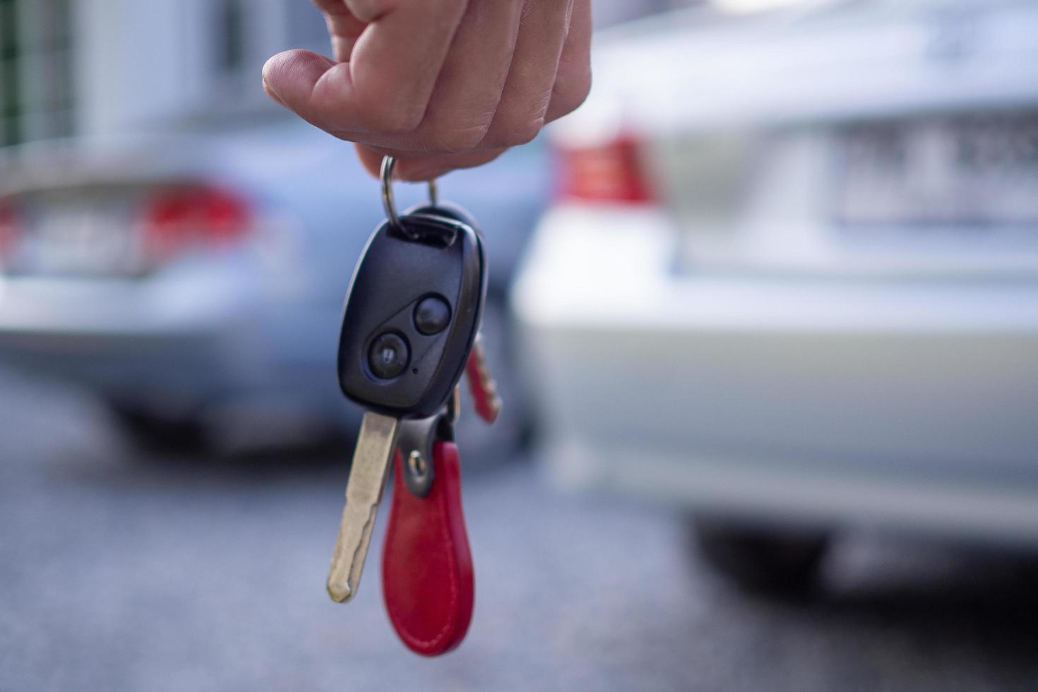 The car salesman and the key to the new owner. photo