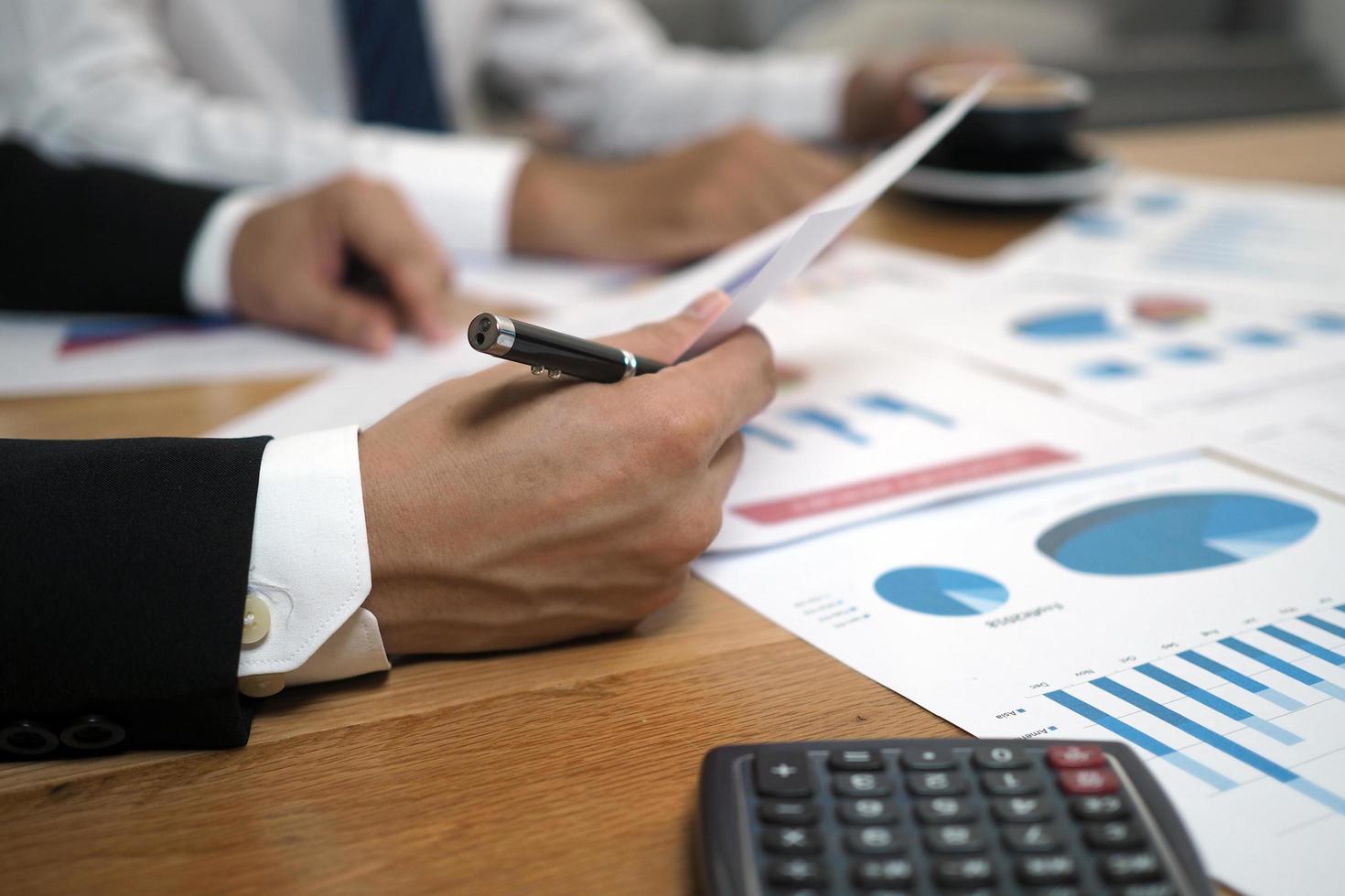 Businessmen together brainstorm ideas for calculating statistical data of investment budgets, making new projects. photo
