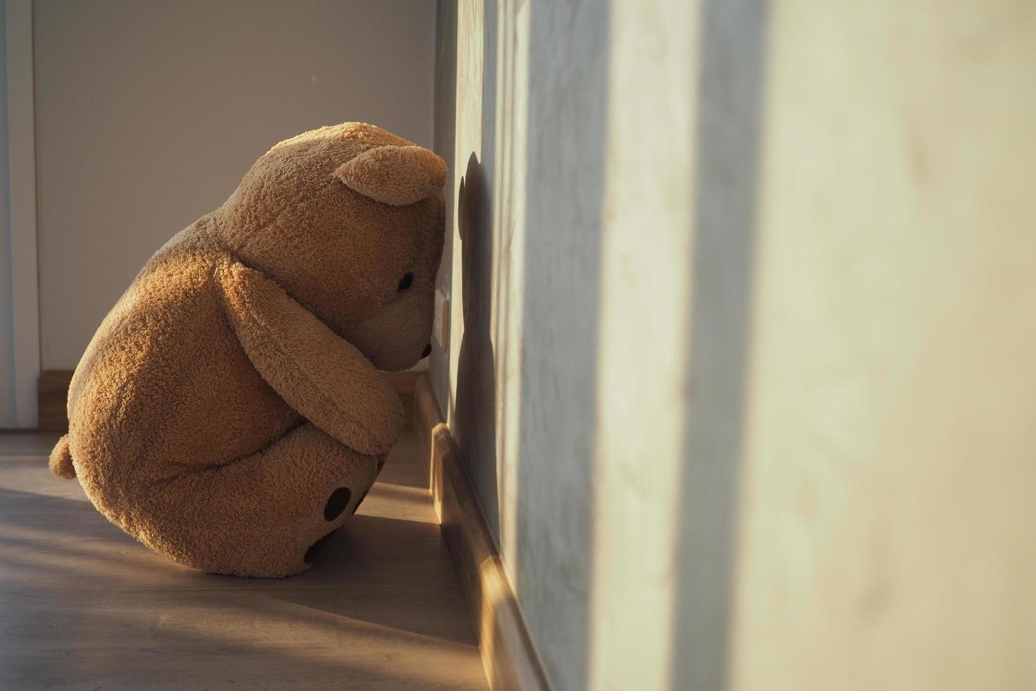 Child concept of sorrow. Teddy bear sitting leaning against the ...