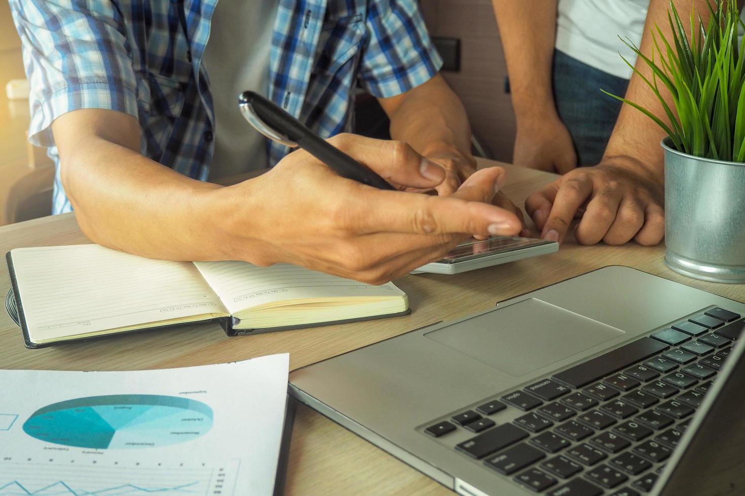 Man hand is clarifying And explain the work of financial analysis to another man. Advice and explain concept photo