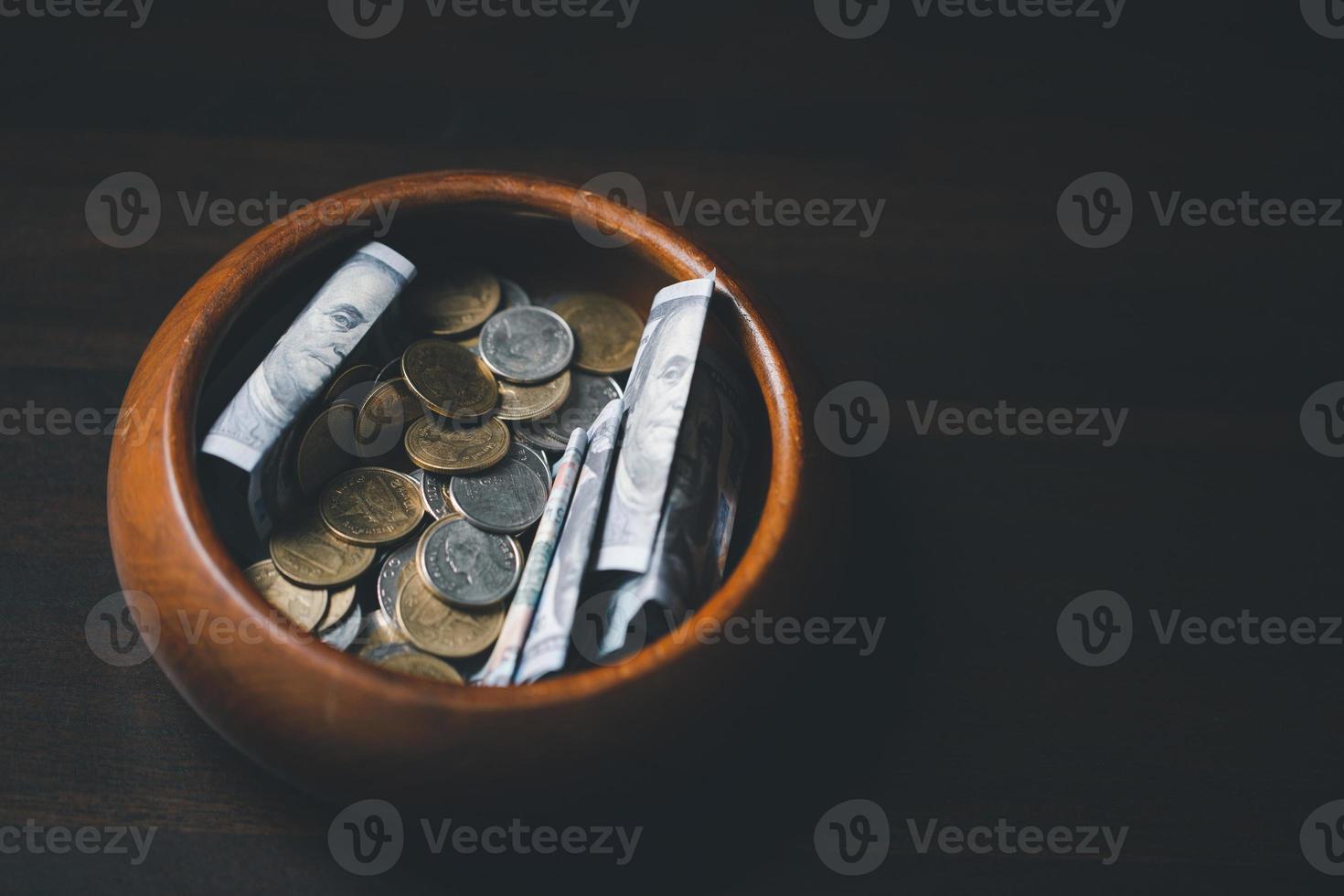One tenth or tithe is basis on which Bible teaches us to give one tenth of first fruit to God. coins with Holy Bible. Biblical concept of Christian offering, generosity, and giving tithes in church. photo