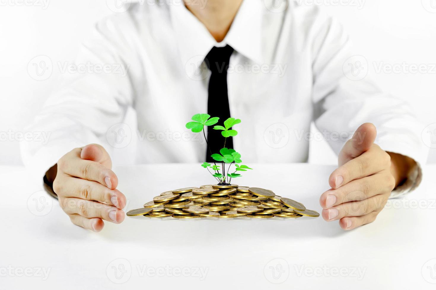 businessman hands protecting piles of golden coins,Lucky economic growth concept photo