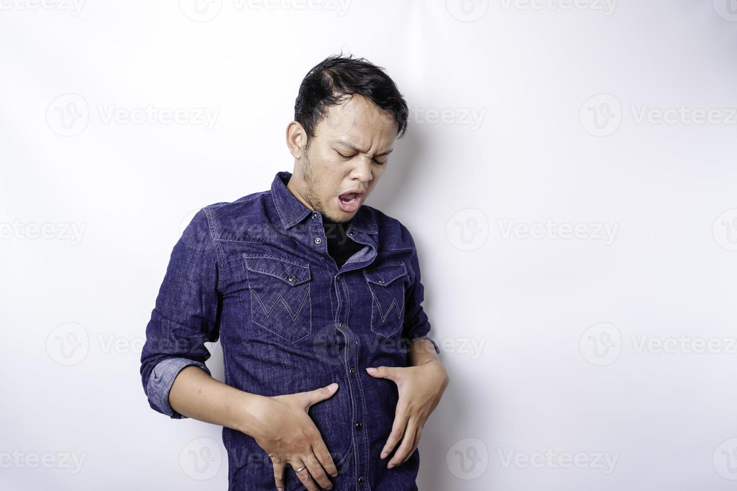 A portrait of insecure Asian fat man is holding the fat on his belly photo