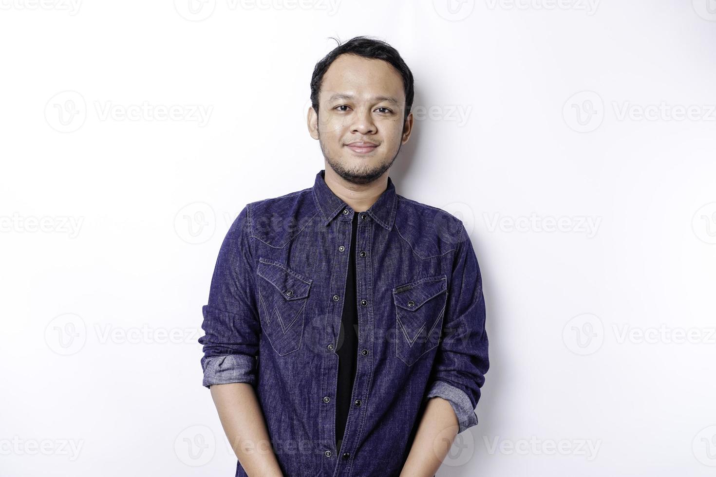 A portrait of a smiling Asian man dressed in a blue shirt, isolated by white background photo