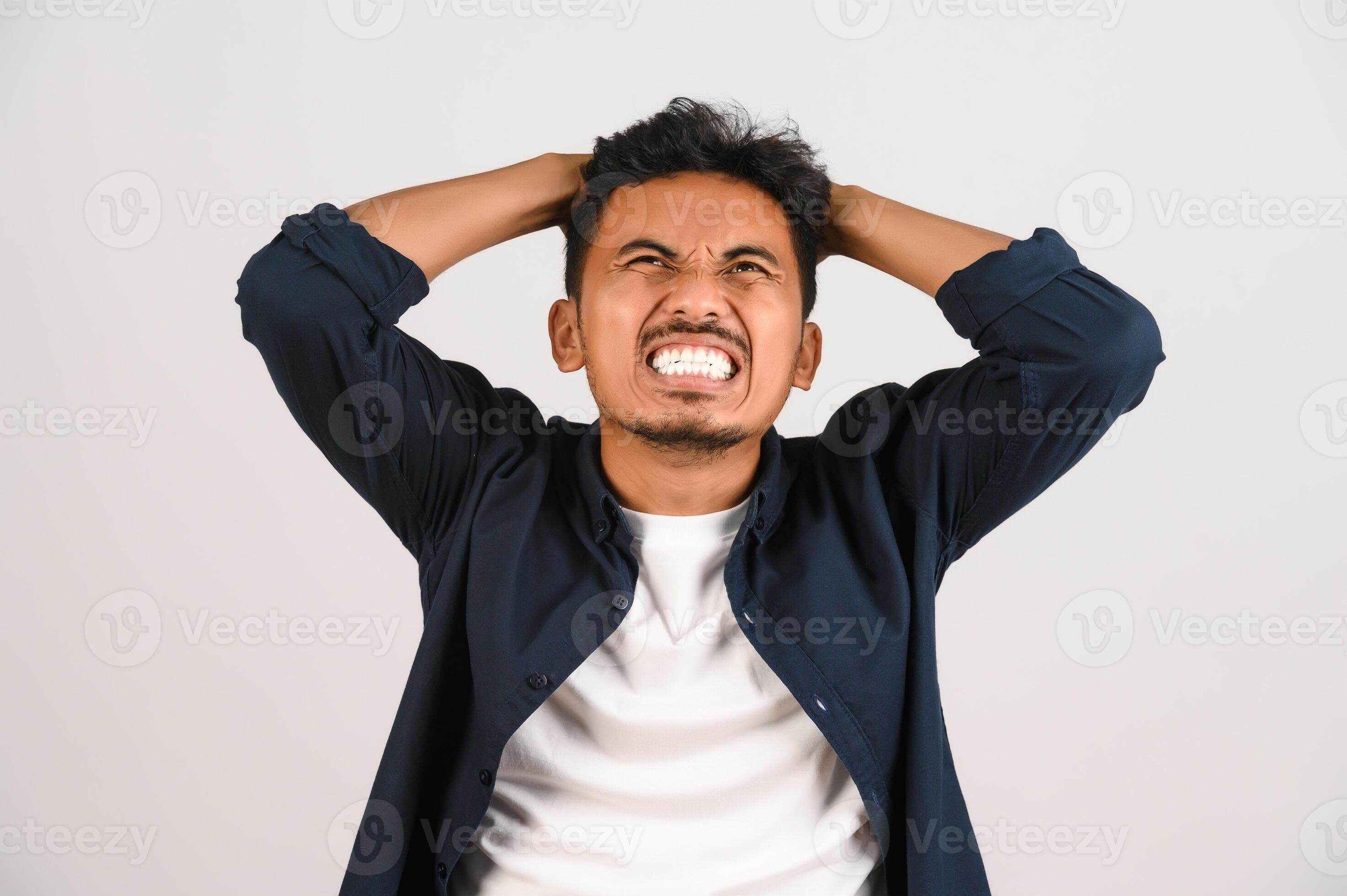 Portrait of Disappointed young asian man in blue shirt annoyed angry in Portrait of Disappointed young asian man in blue shirt annoyed angry in