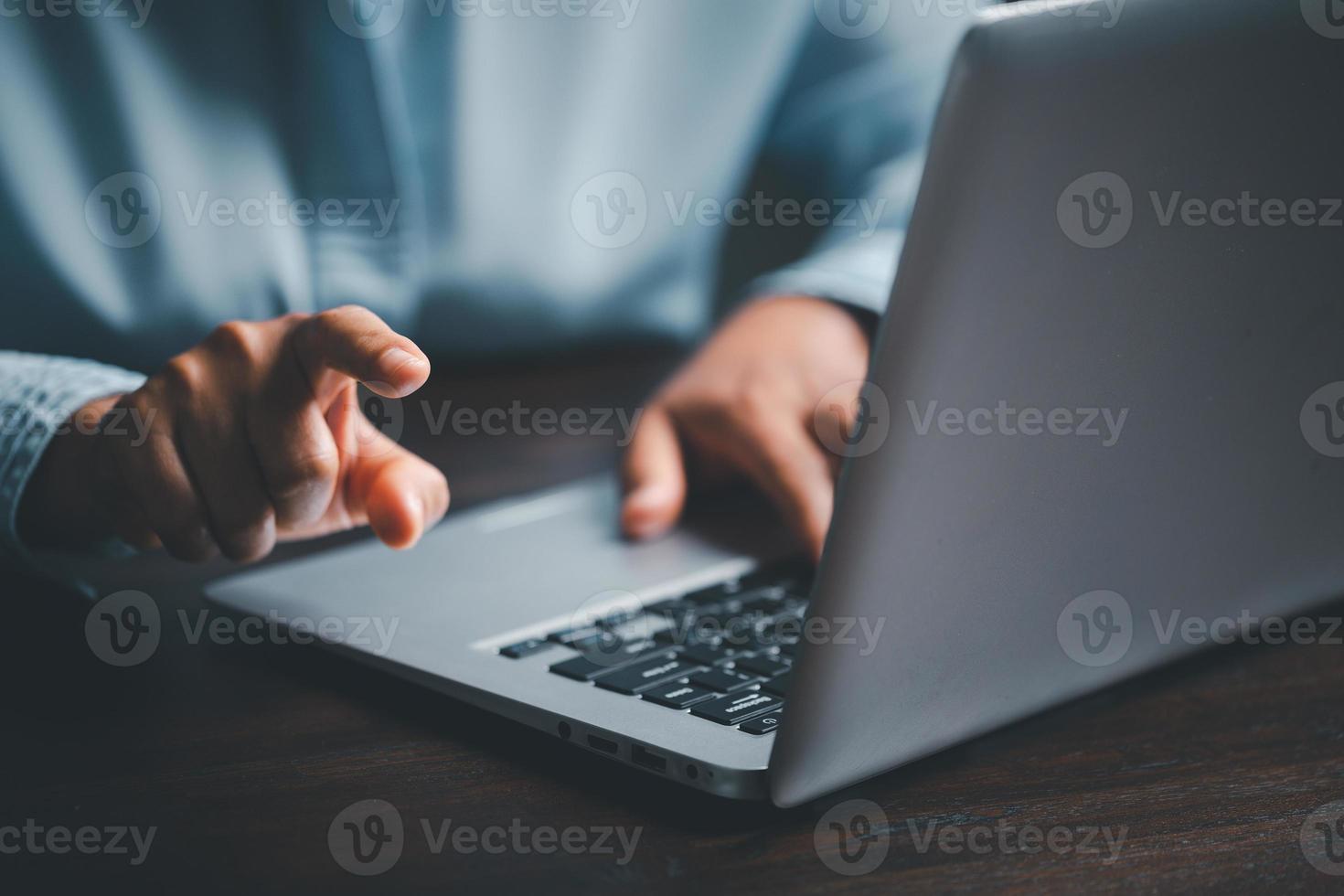 Woman person hands with laptop computer on wooden table for business or technology background. photo