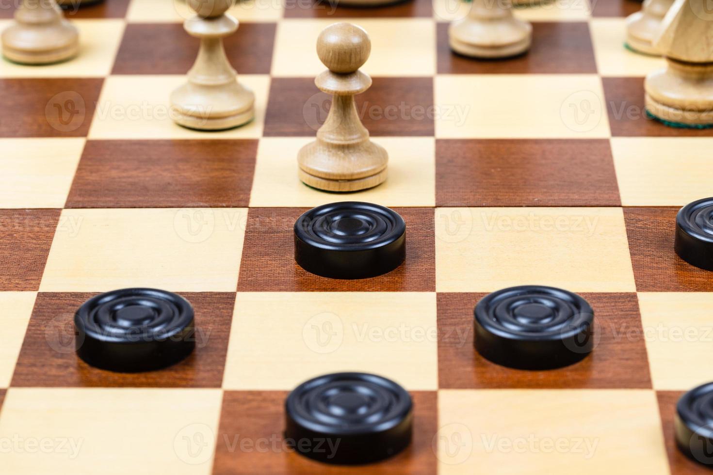 pawn and checkers piece in center of board closeup photo