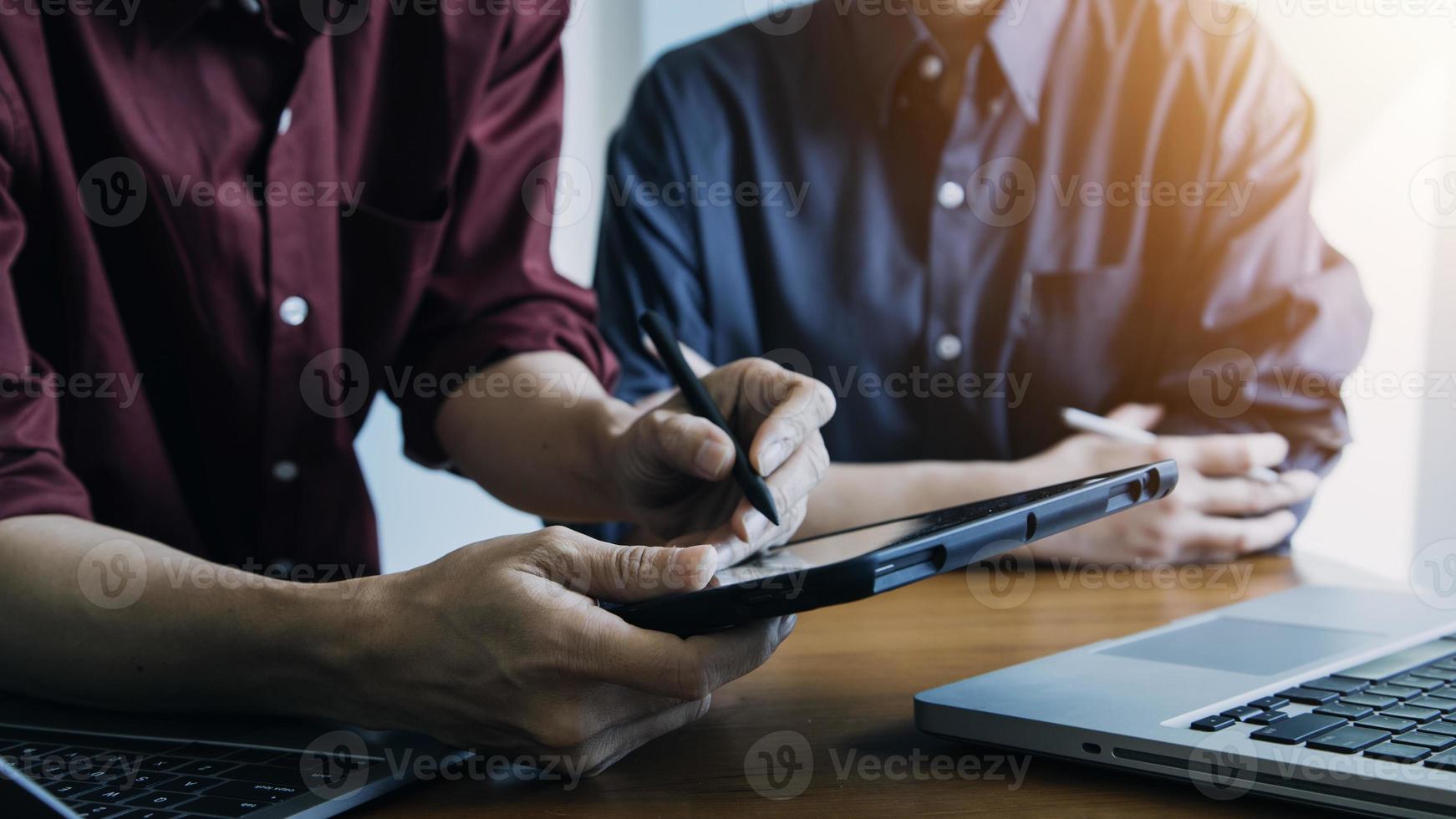 close up hands multitasking man using tablet, laptop and cellphone connecting wifi photo