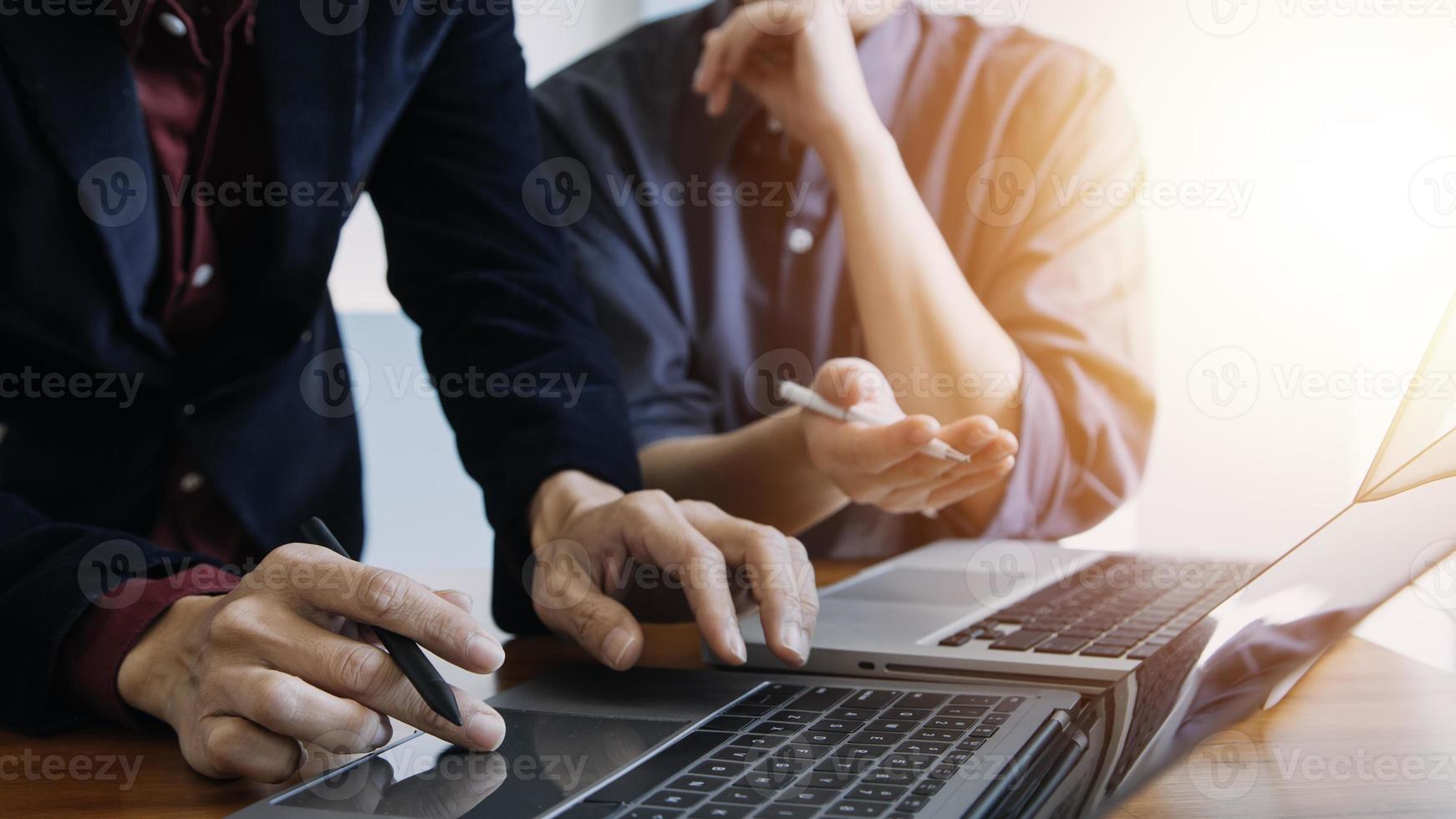 close up hands multitasking man using tablet, laptop and cellphone connecting wifi photo