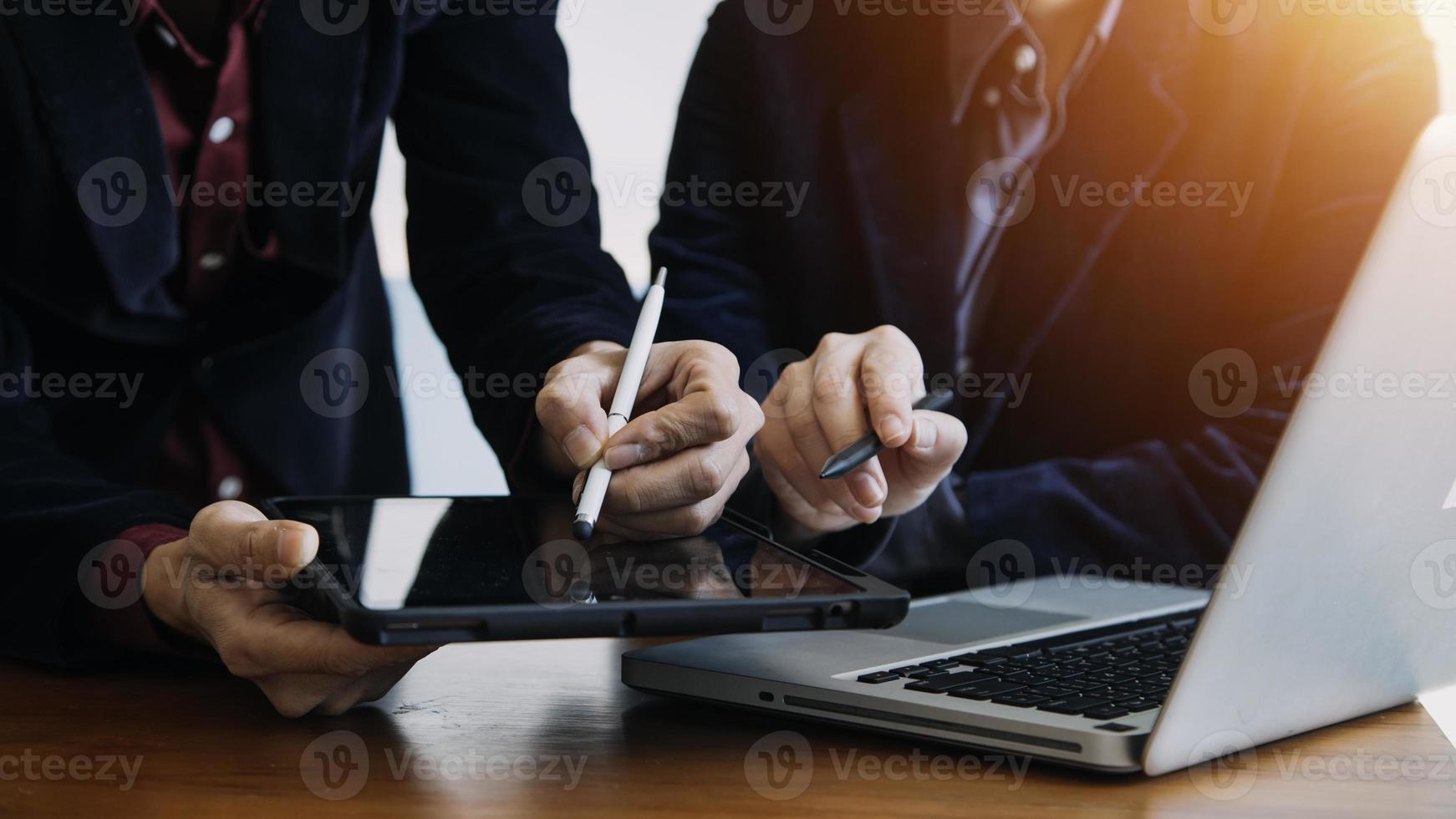 close up hands multitasking man using tablet, laptop and cellphone connecting wifi photo