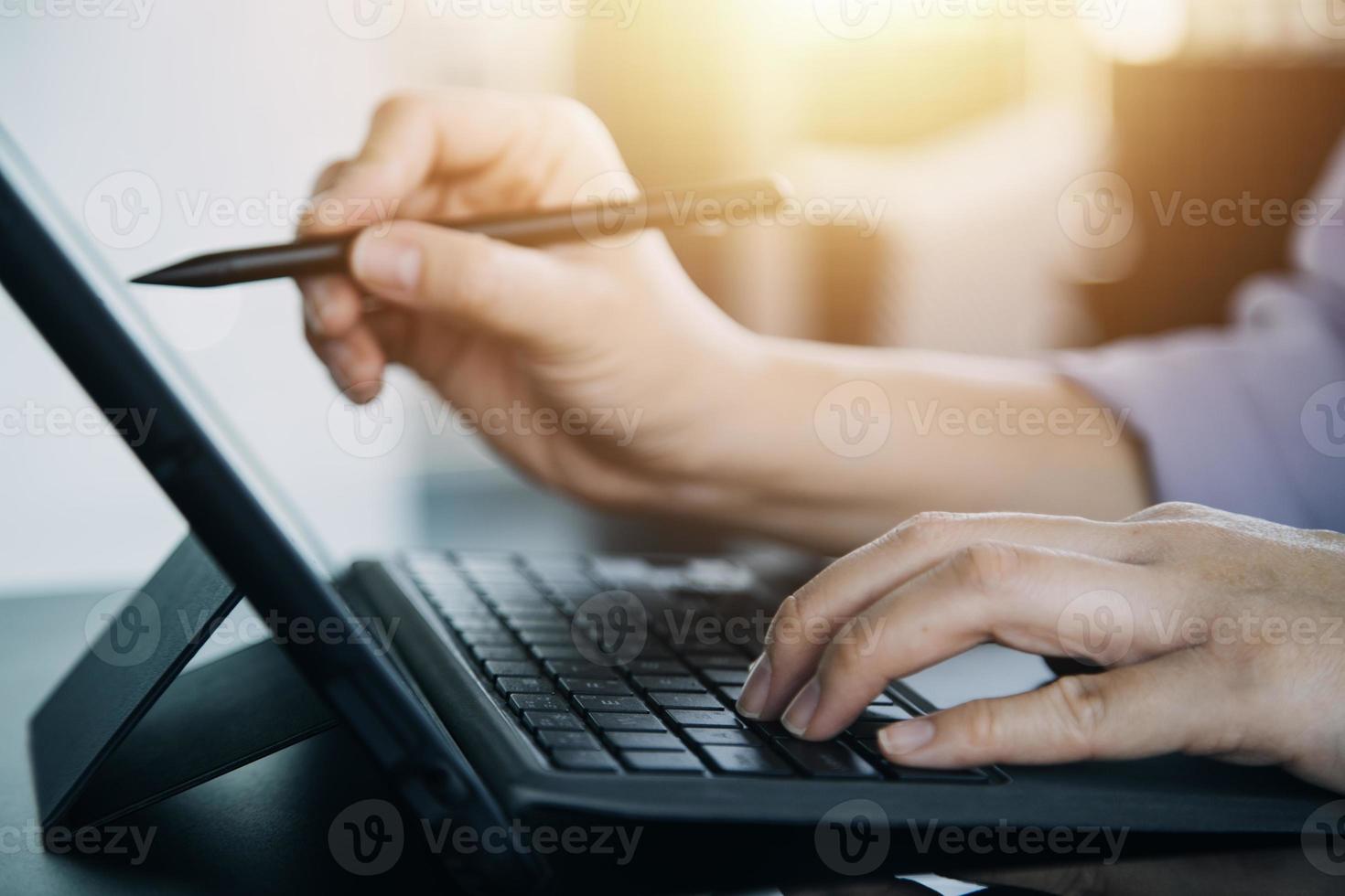 close up hands multitasking man using tablet, laptop and cellphone connecting wifi photo