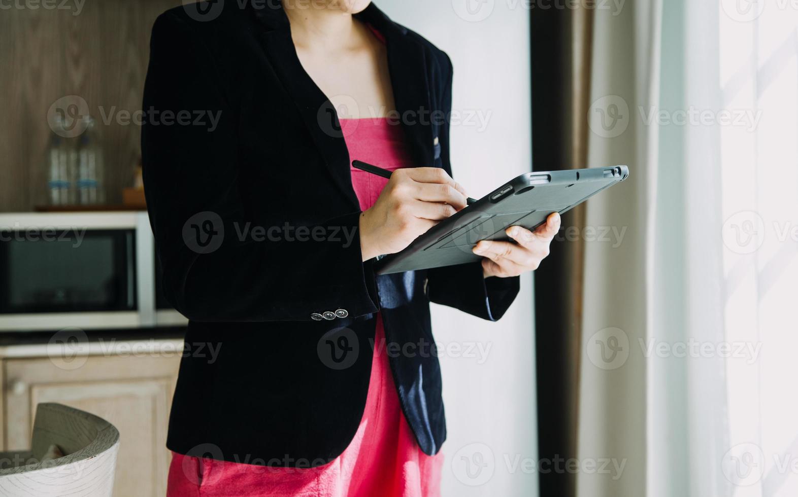 Mature businessman using a digital tablet to discuss information with a younger colleague in a modern business lounge photo