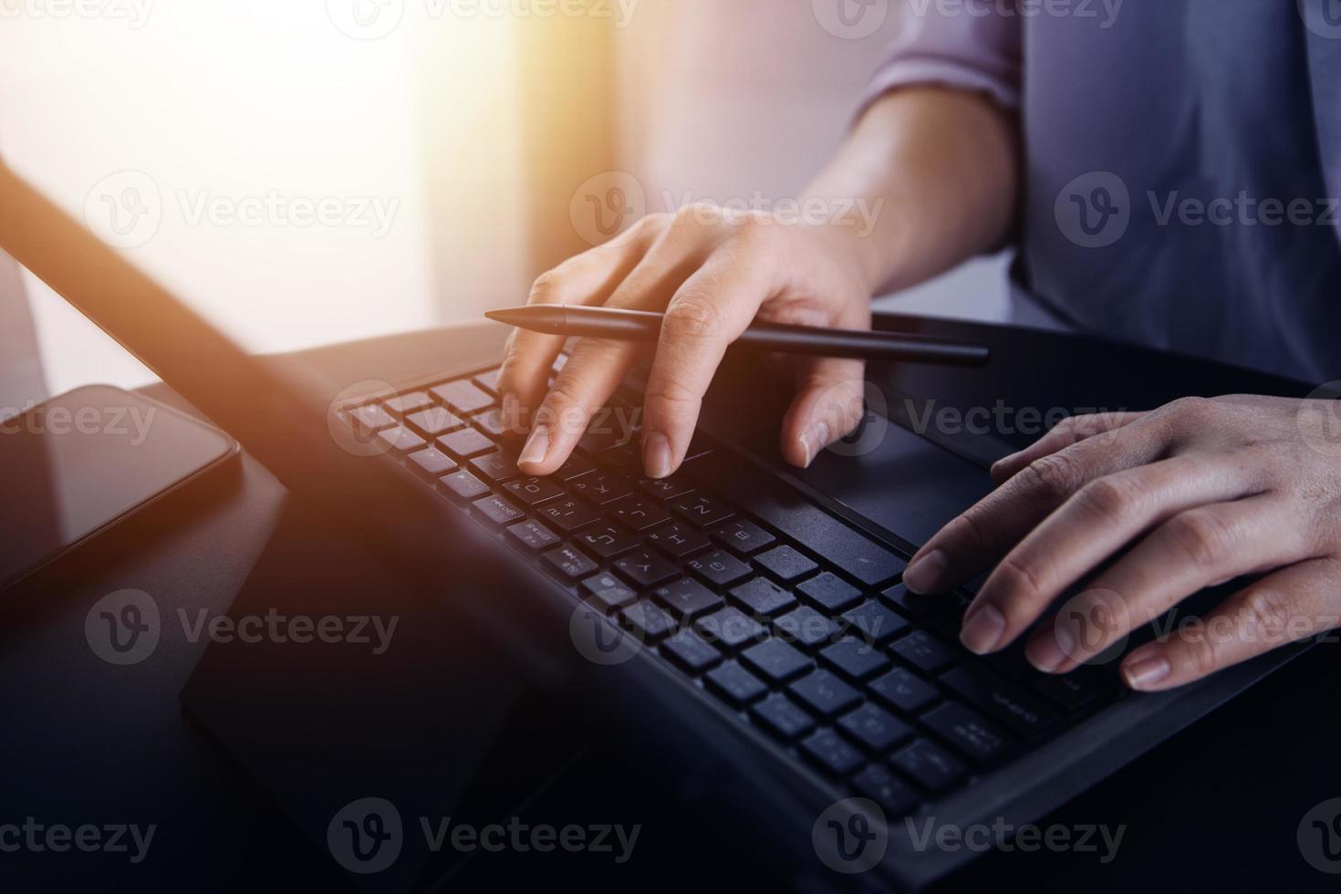 close up hands multitasking man using tablet, laptop and cellphone connecting wifi photo