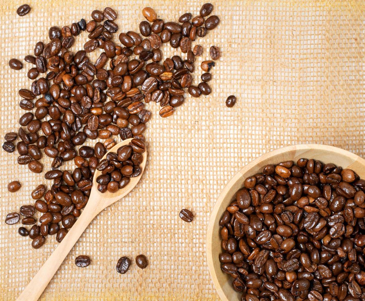 Roasted coffee beans is ready to grind on a wooden table photo