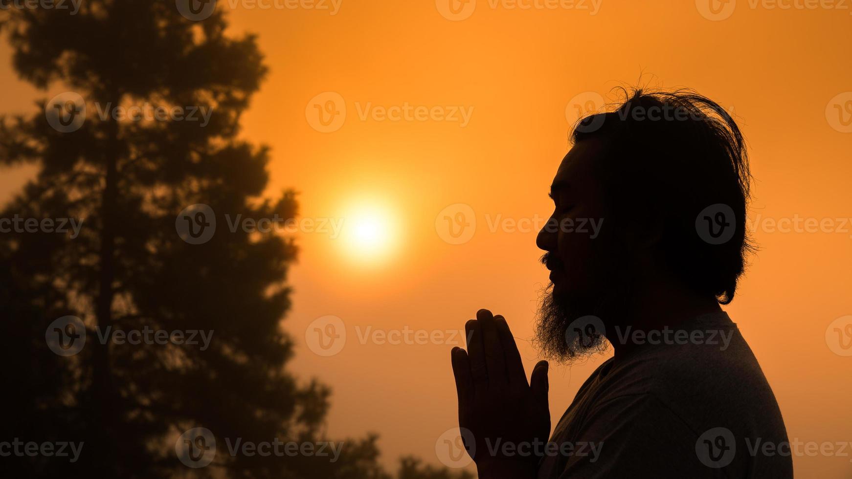 Worship with faith of christian concept. Spiritual prayer hands over sunshine with blurred beautiful sunrise sunset background. Preacher pray to God in morning with devotion. Christian man have hope. photo