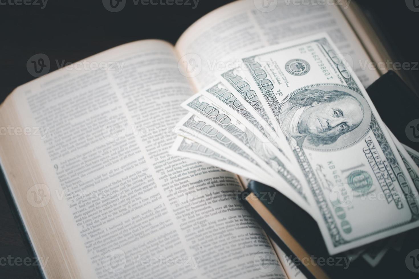 One tenth or tithe is basis on which Bible teaches us to give one tenth of first fruit to God. coins with Holy Bible. Biblical concept of Christian offering, generosity, and giving tithes in church. photo