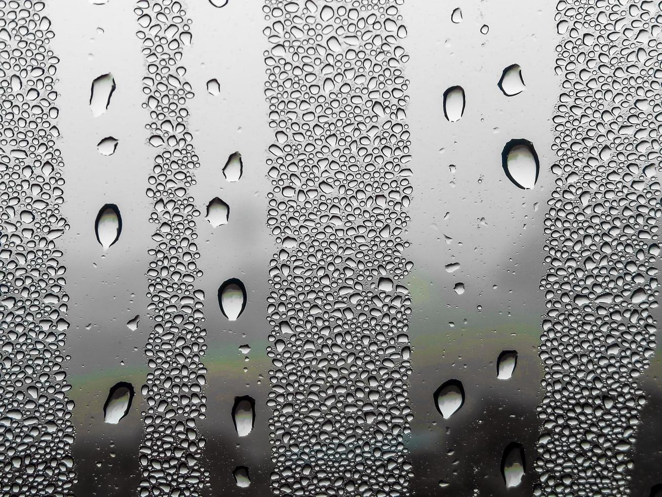 gotas de lluvia sobre fondo de desenfoque de vidrio concepto de temporada de lluvias, pronóstico del tiempo departamento meteorológico clima mala visibilidad clima frío dormir para dormir foto