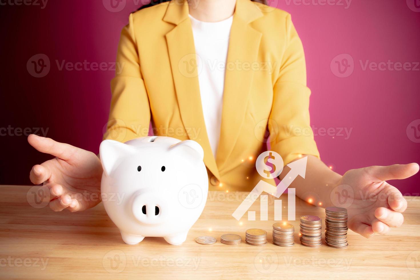 Businesswoman with rows of coins with graph for finance and business concept. coins with piggy bank. Save money for prepare in the future. account finance bank business. pink background. photo