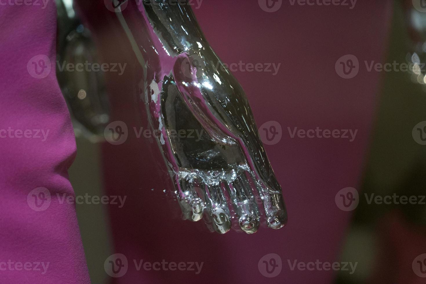 Silver woman mannequin hand detail with pink dress photo