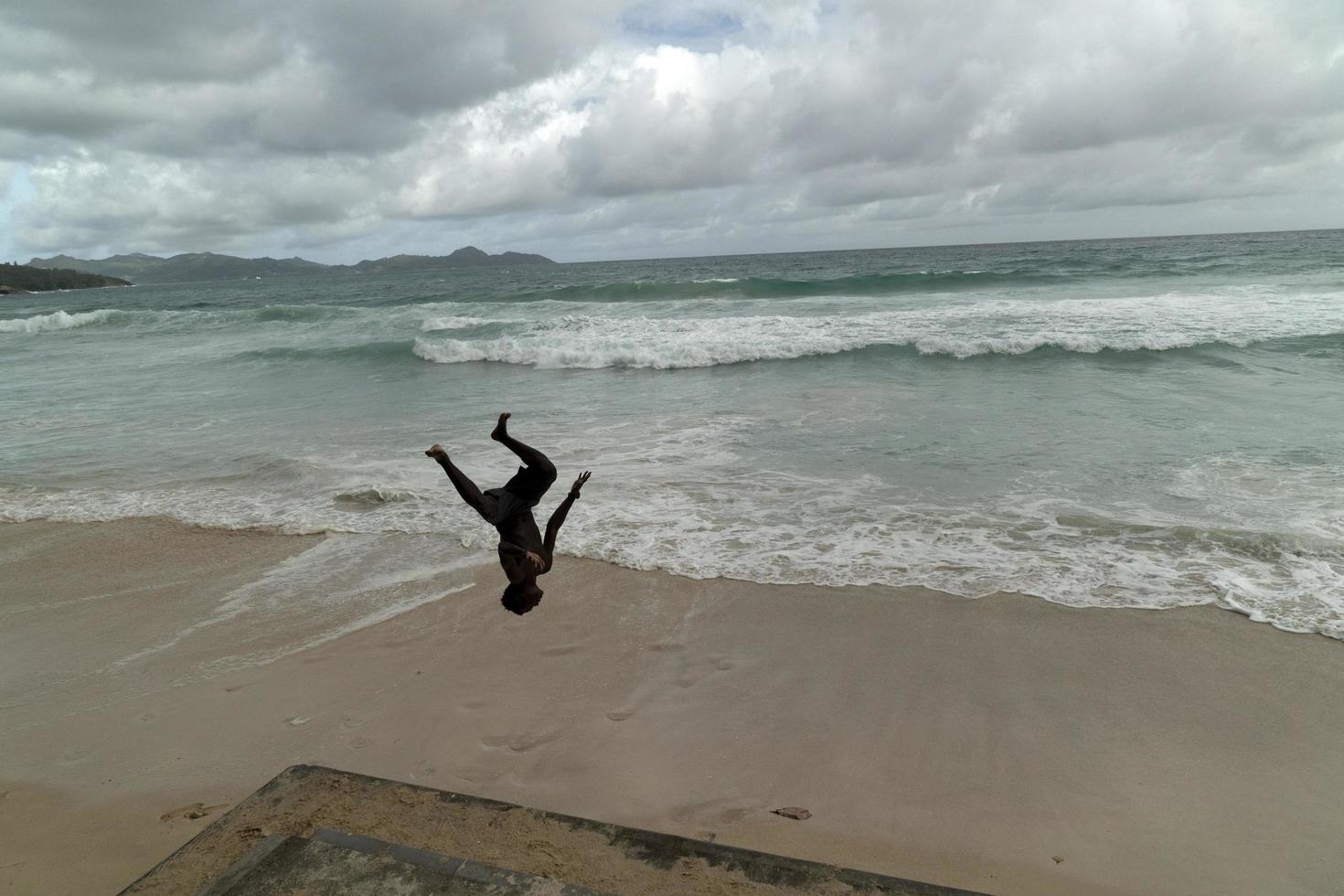 MAHE, SEYCHELLES - AUGUST 13 2019 - Young creole people having fun on the beach photo