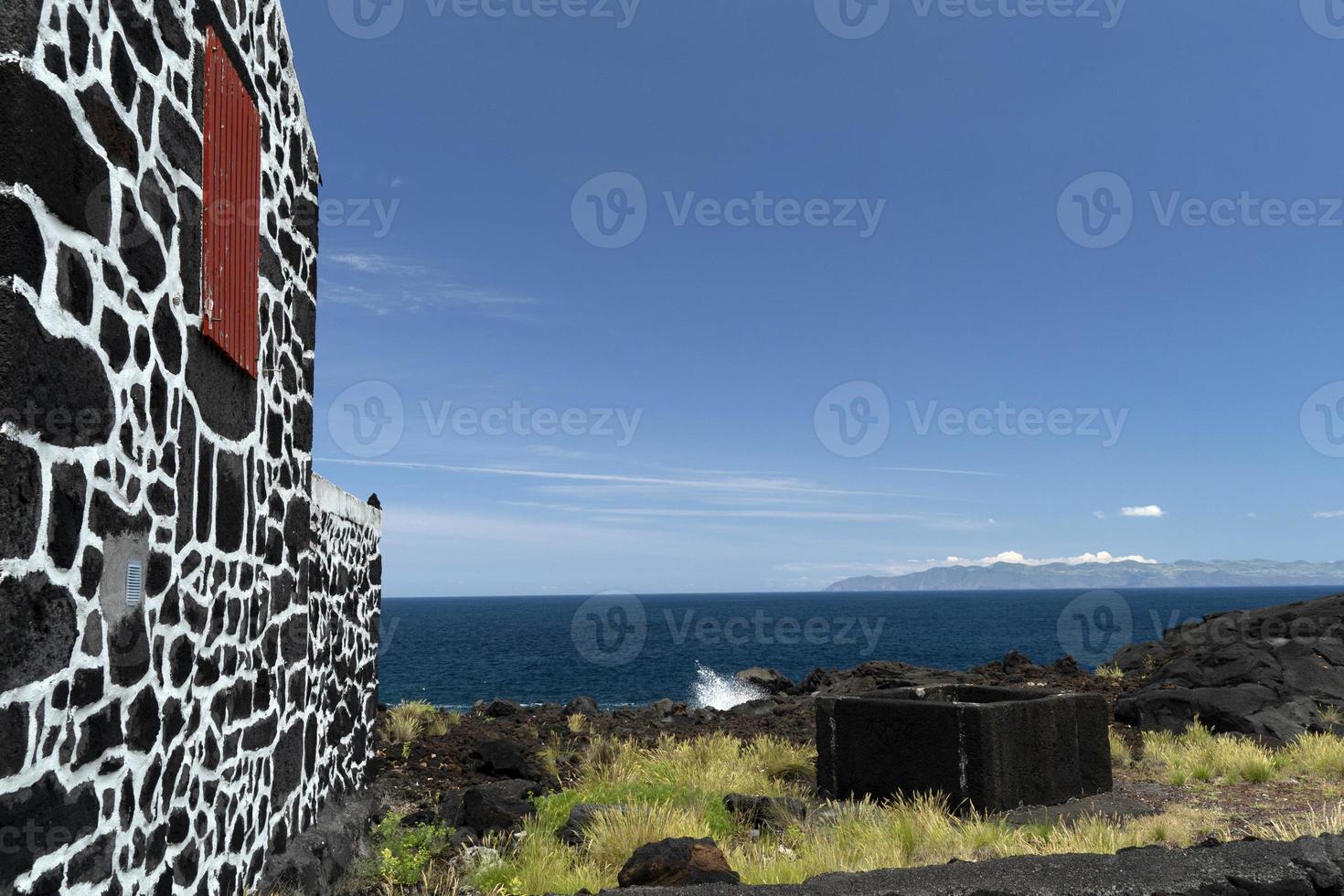 Lajido village Pico Island Azores black lava houses red windows photo