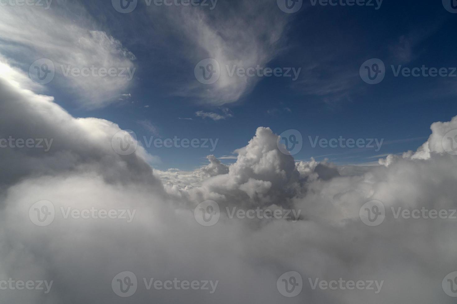 cloudy sky from airplane window while flying photo