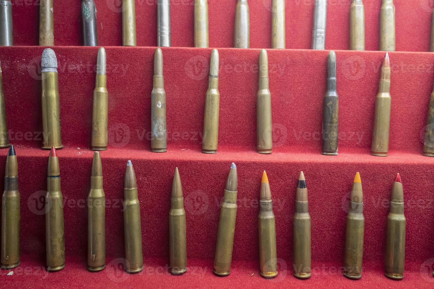 many war gun bullets close up on red photo