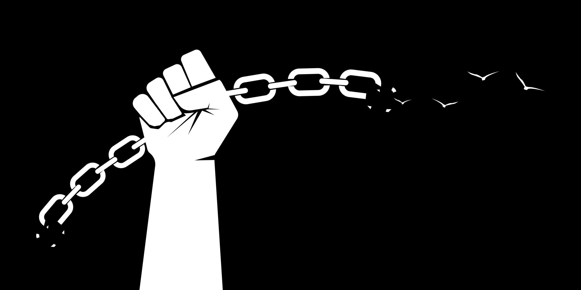 A fist and a broken chain. Freedom concept. Broken chain and birch