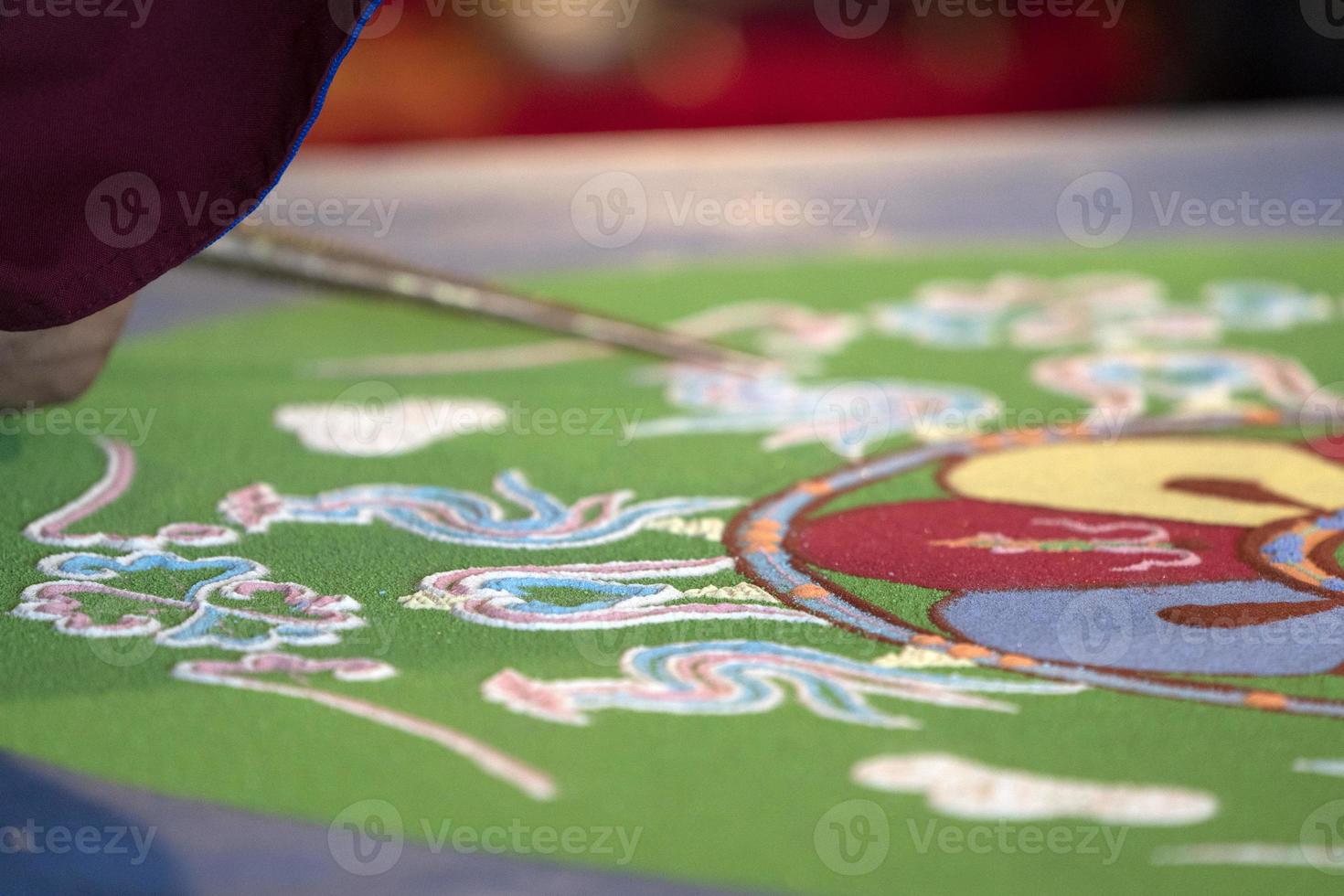 Tibetan monk mandala sand drawing photo