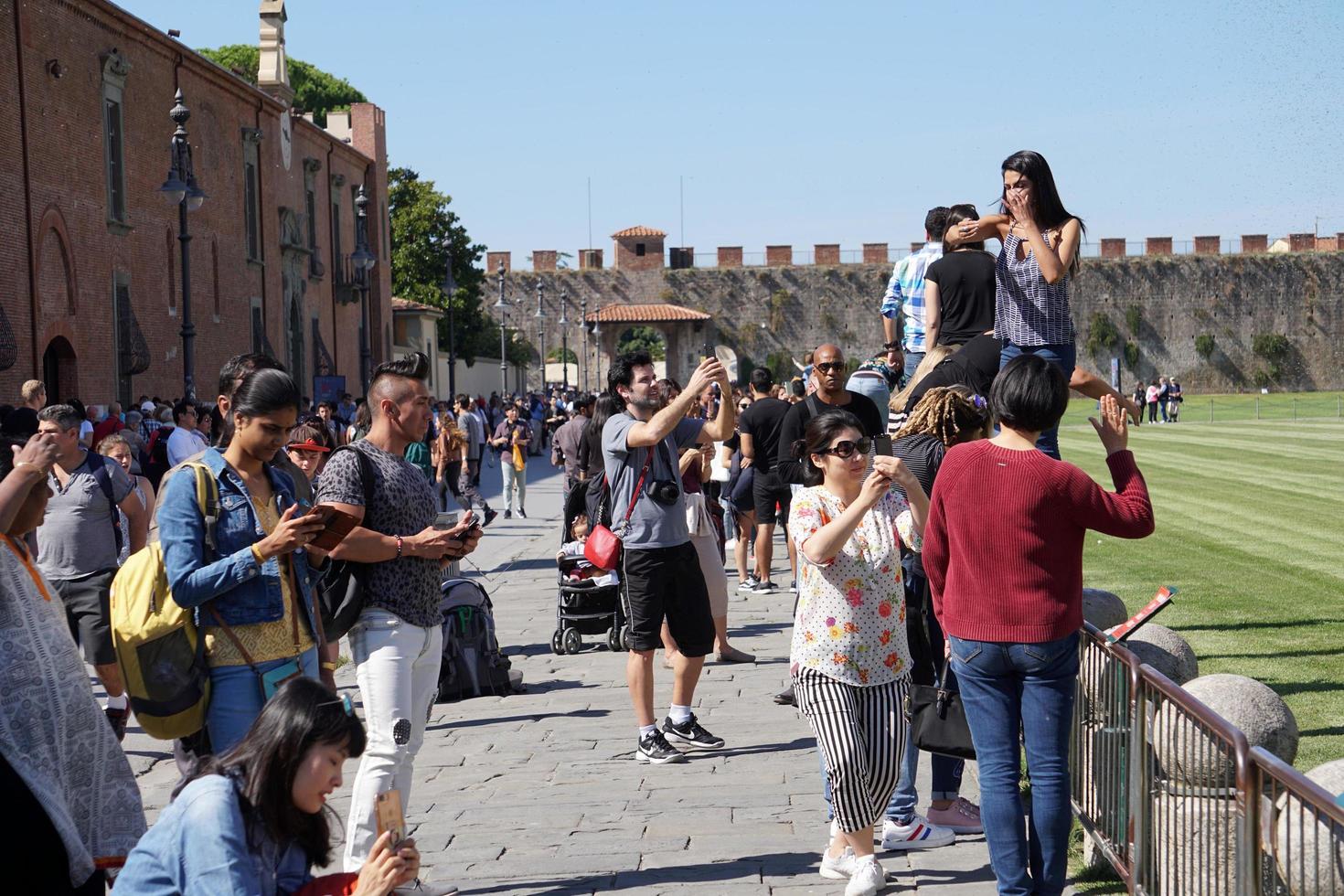 PISA, ITALY - SEPTEMBER 26 2017 - Tourist taking pictures at famous leaning tower photo