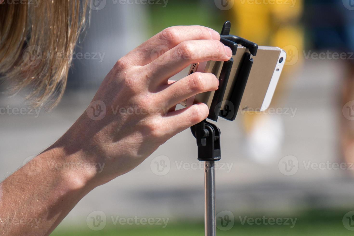 hand taking selfie picture with smartphone photo