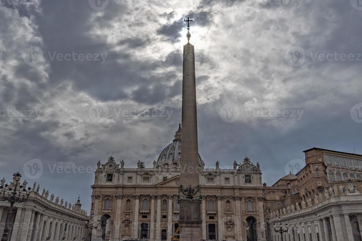 Vatican Place and Saint Peter Church cross on cloudy sky photo