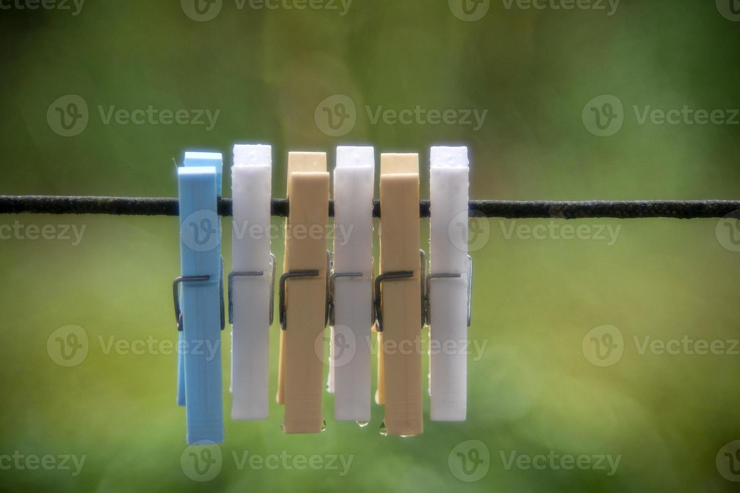 clothespin detail isolated on bubble green bokeh photo