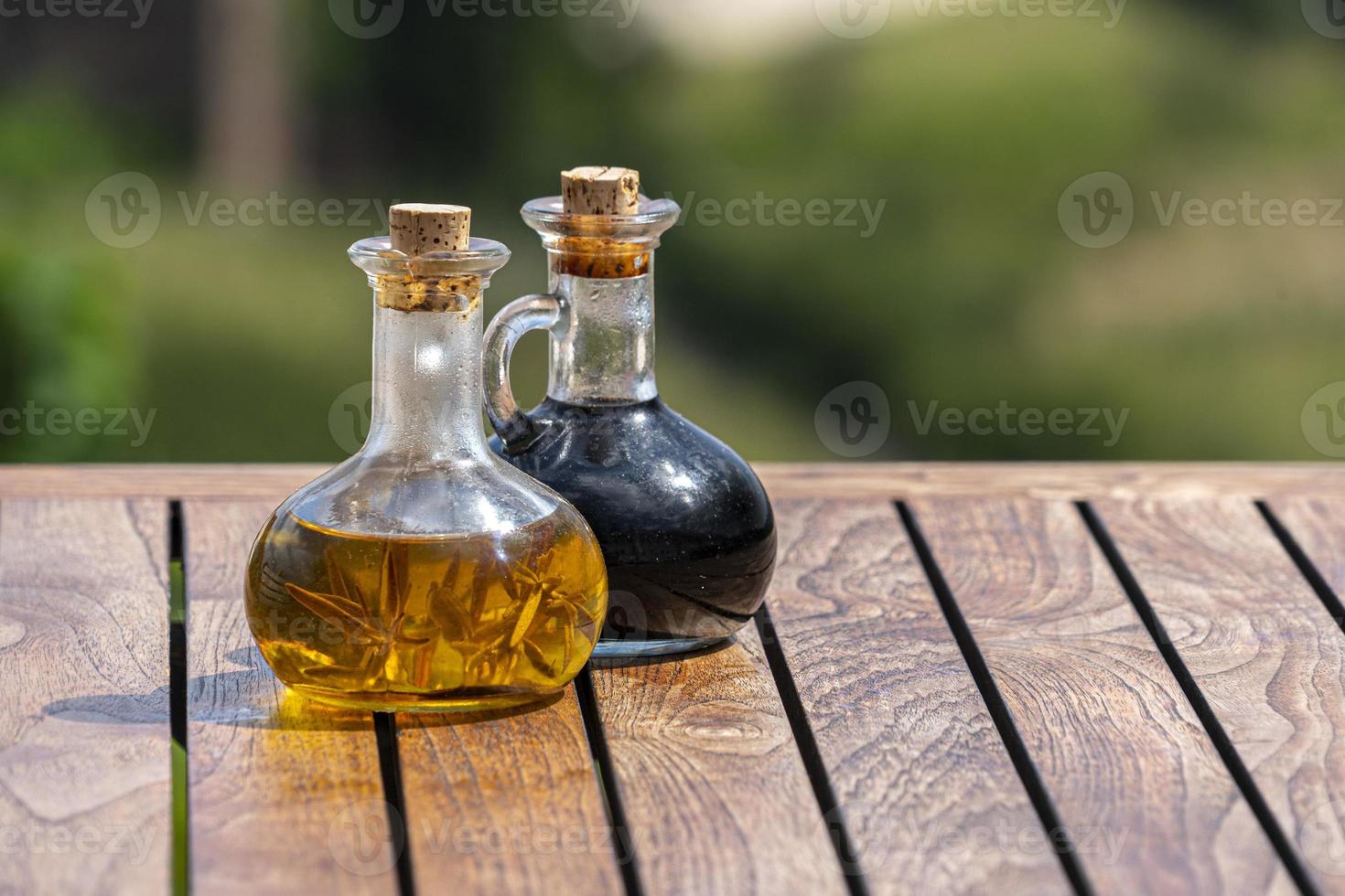 oil and vinegar on wooden table photo