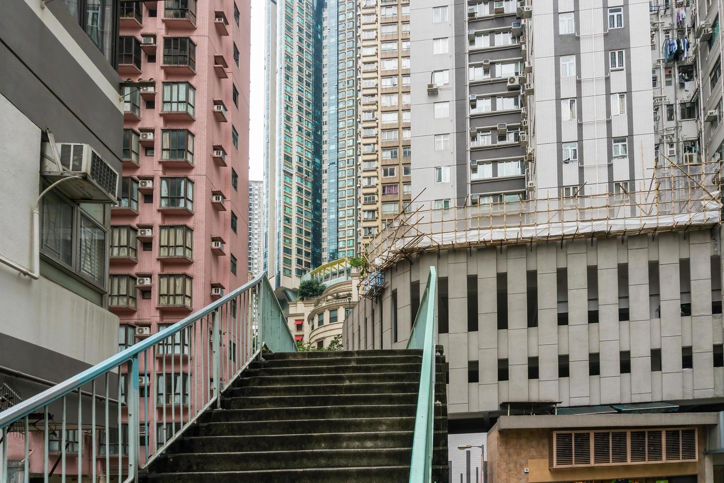 Hong Kong,March 25,2019-people among the skyscrapers through the streets of Hong Kong during a cloudy day photo