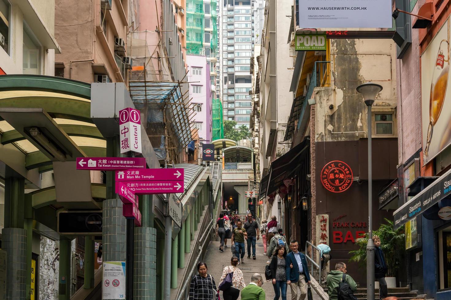 Hong Kong,March 25,2019-people among the skyscrapers through the streets of Hong Kong during a cloudy day photo