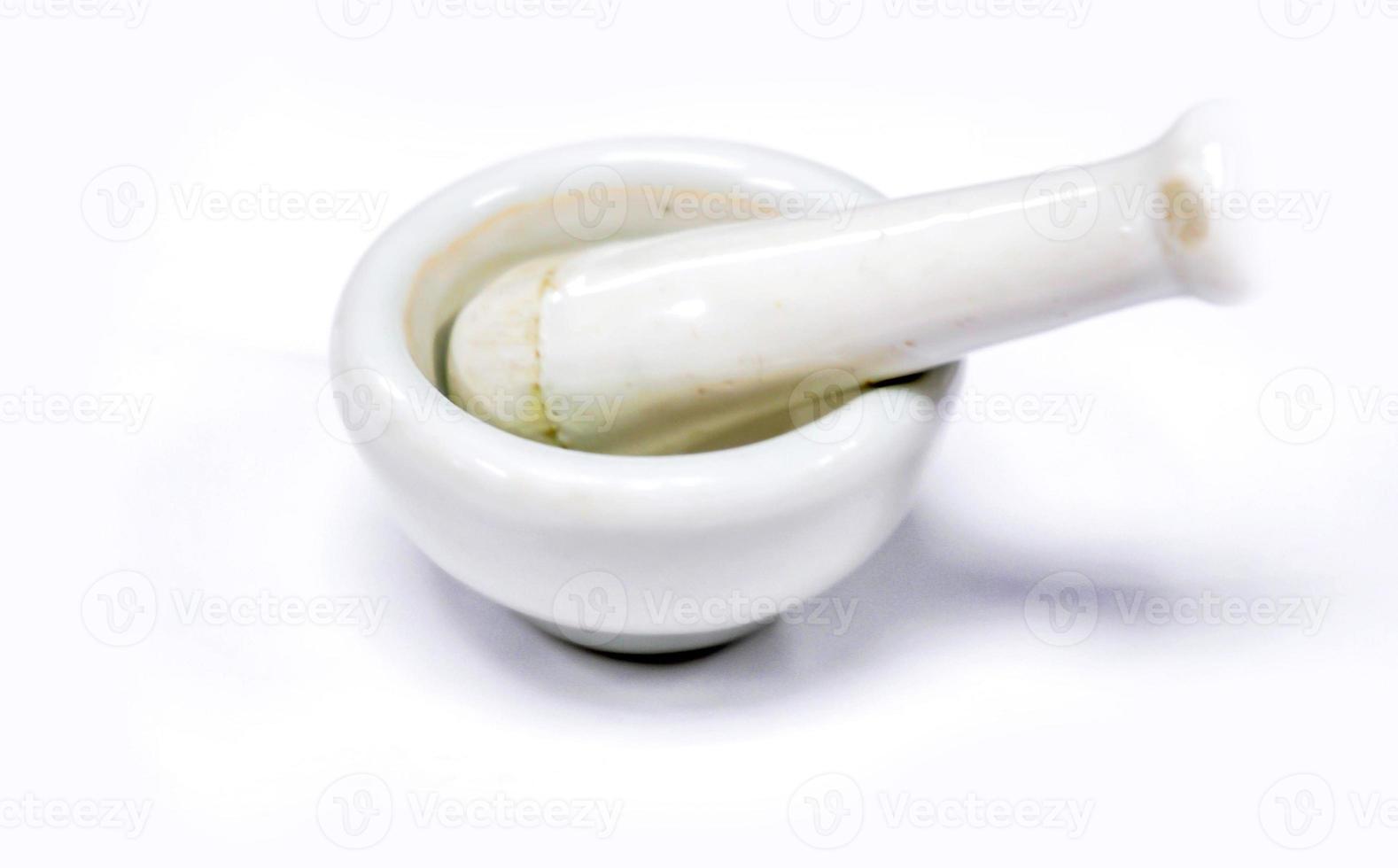 Herbs and medicine small white mortar, Made by lime or ceramic on white background. photo