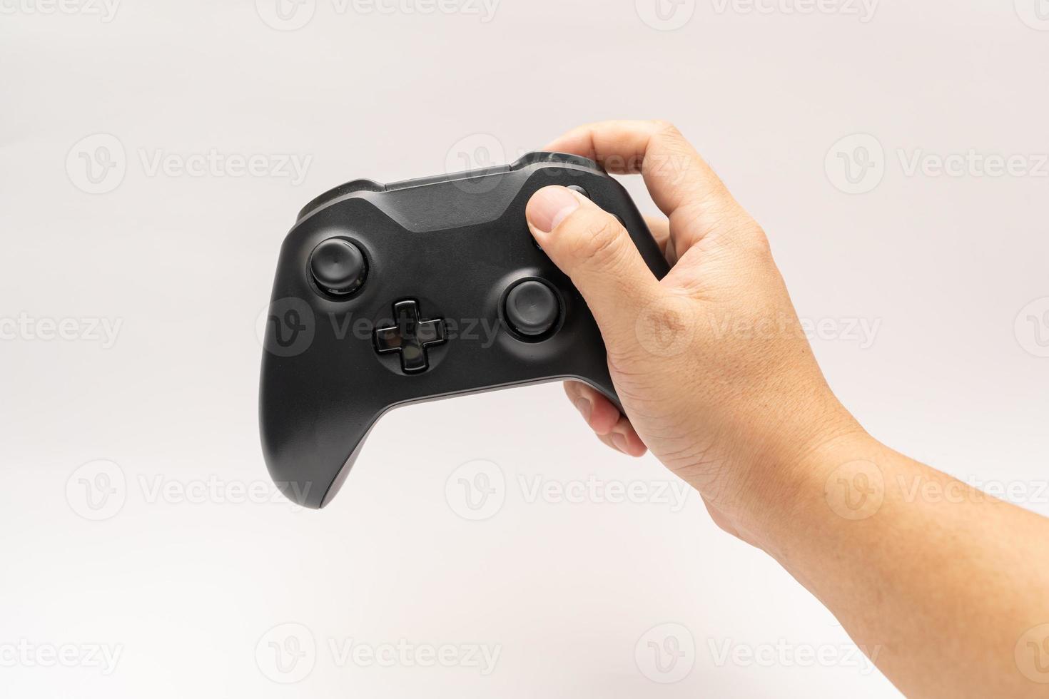 game controller with hand on white background. Black game controller isolated background. photo