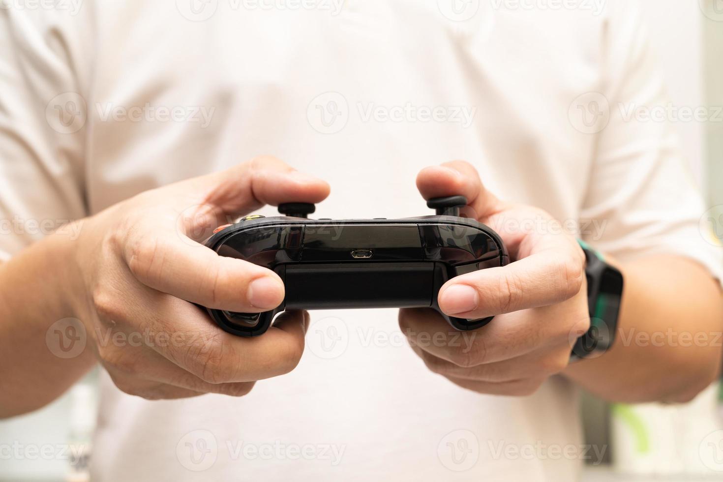 Black joystick in hands isolated on white background. Computer gaming technology play competition video game control confrontation concept. esport concept. photo