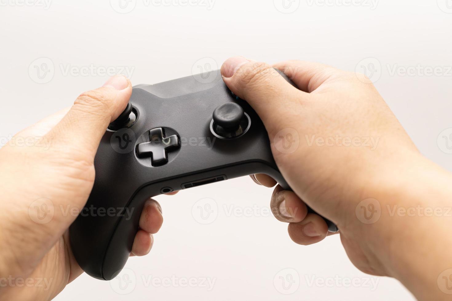 Black joystick in hands isolated on white background. Computer gaming technology play competition video game control confrontation concept. esport concept. photo