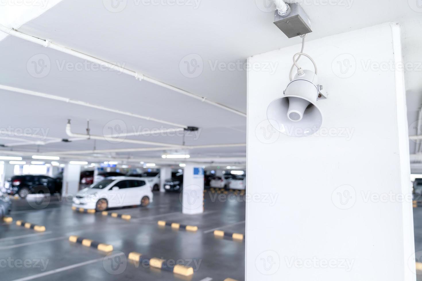 A Megaphone speaker is set up on the pole ceilling in car parking area. photo