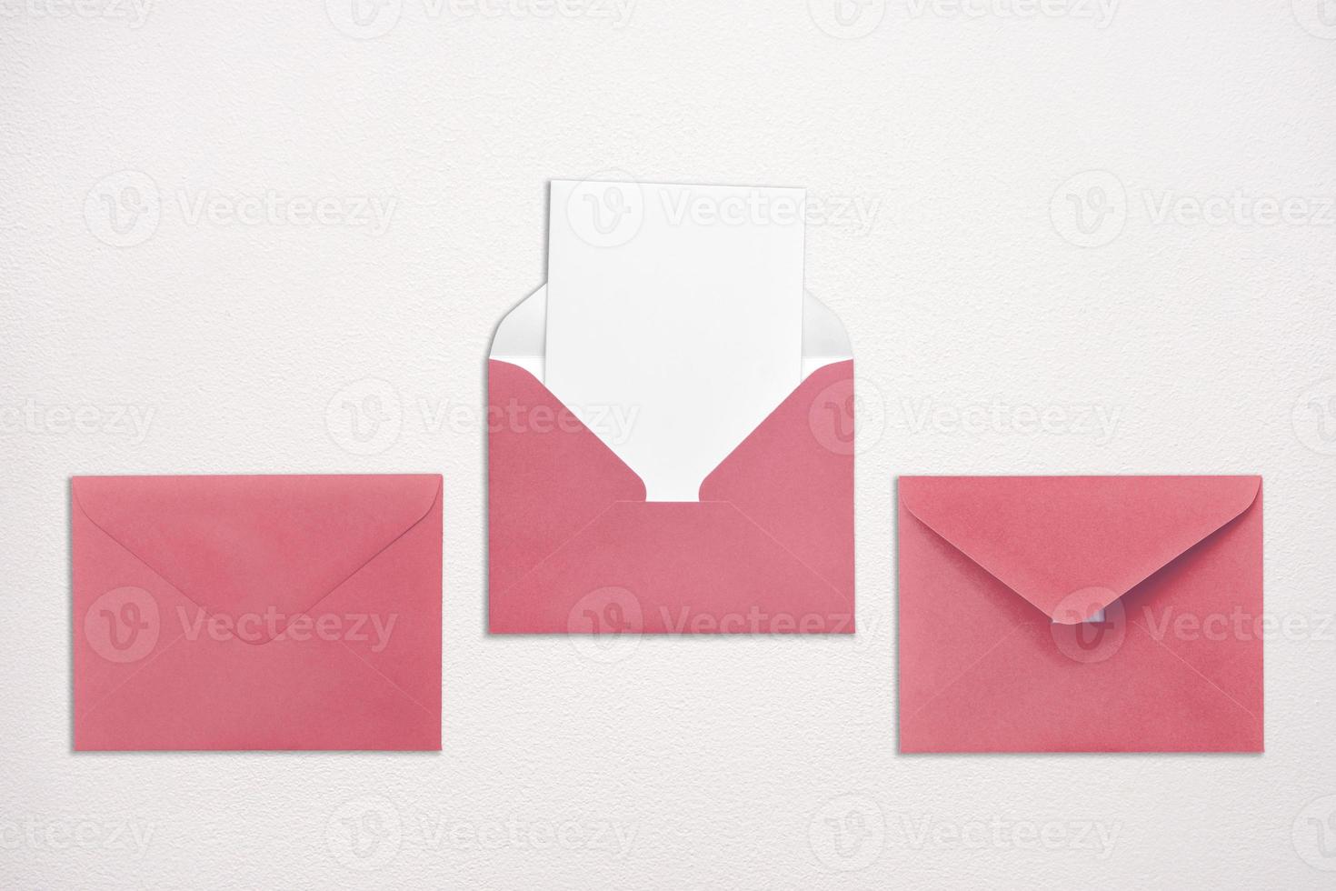 Three pink envelopes on white background one open with a note inside. Place for your text. Delivery service. photo