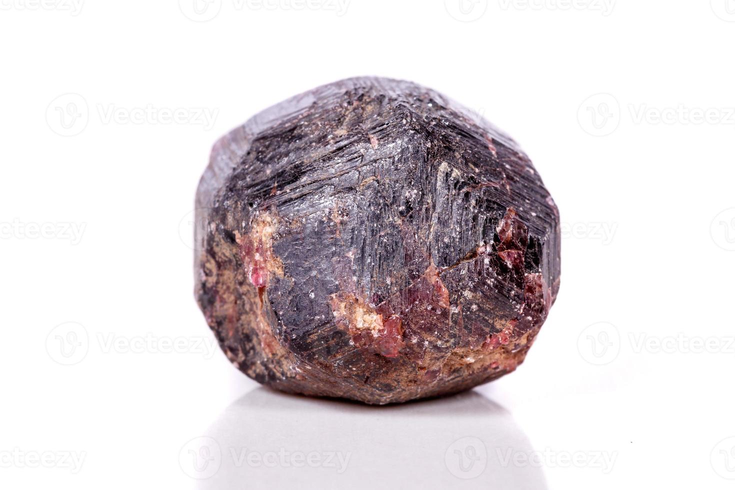 Macro of a mineral garnet stone on a white background photo