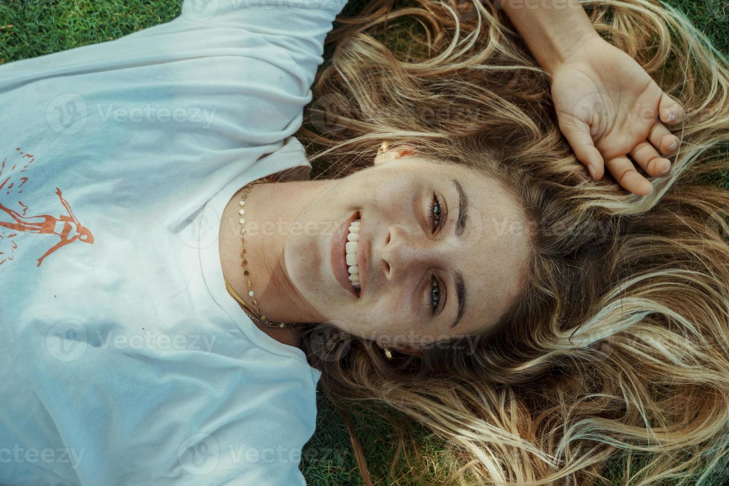 Close up of beautiful young woman looking at camera and smiling. photo