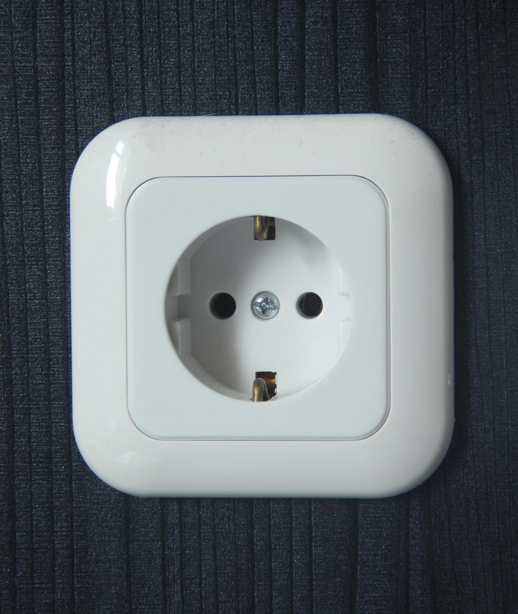 White wall voltage electricity wall socket isolated on wooden wall ...