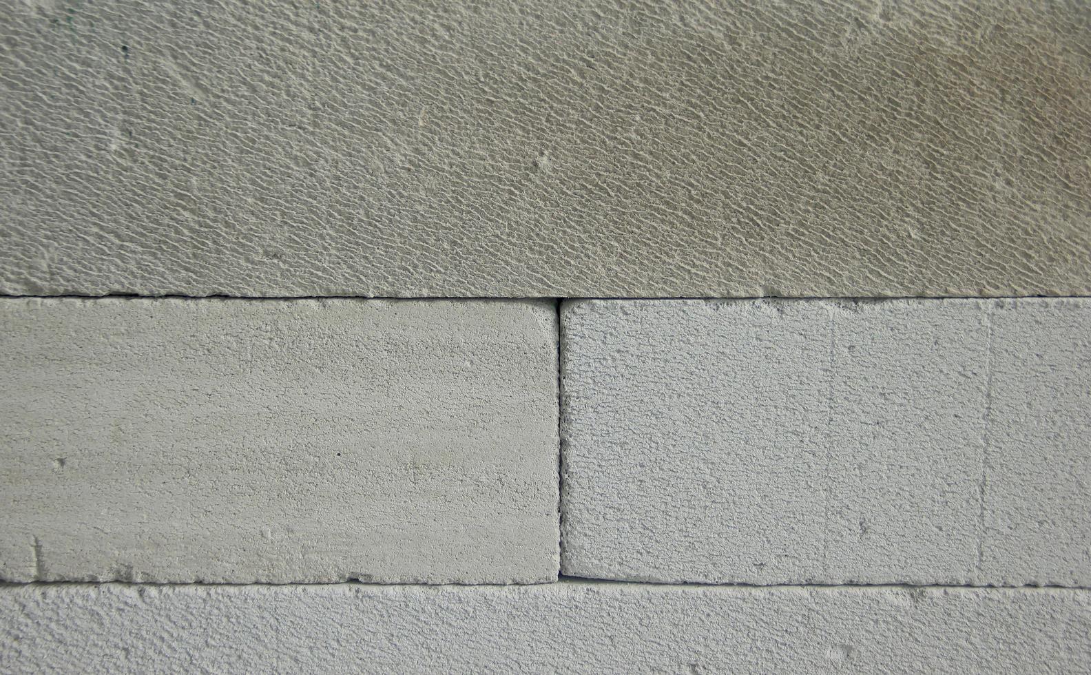 White grunge textured stone wall background. Empty copy space wallpaper. photo