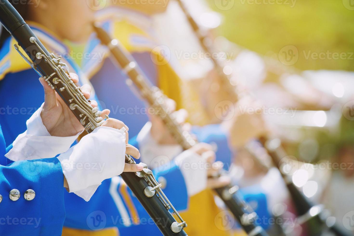 Close up show band parade and details of playing musicians instruments in a marching band performing playing a clarinet  woodwind Instruments. photo